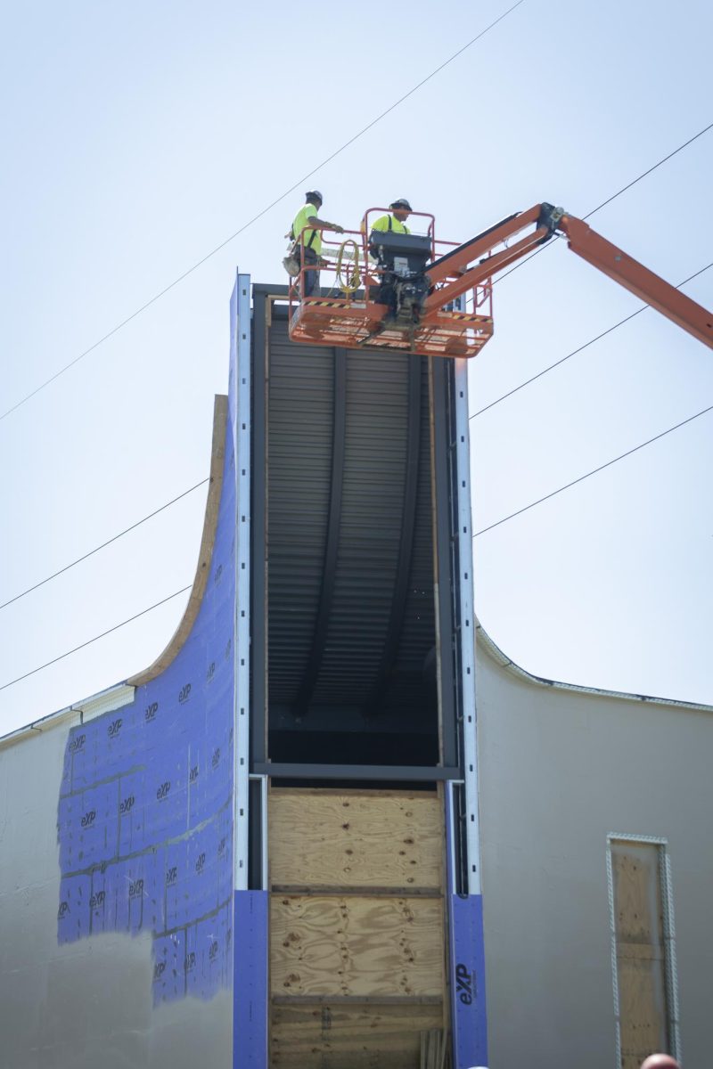 Construction workers placing final beam on the Alvin J. Brooks Center for Faith-Justice on September 6, 2024.