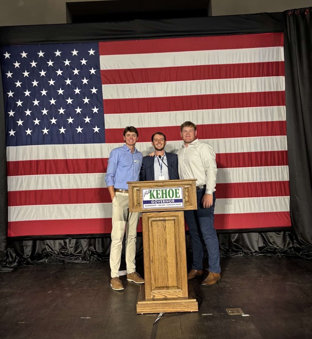 Rockhurst University seniors David Schilp (left) and Aiden Wells (right) supported senior Joseph Fallis (center) as he worked at a campaign event for Mike Kehoe. Photo provided by Fallis.